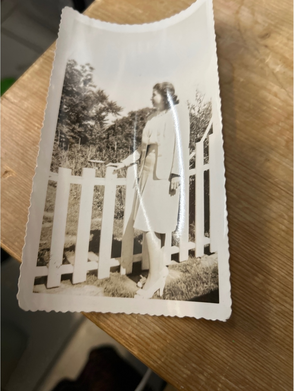 Vintage photo of a woman by picket fence